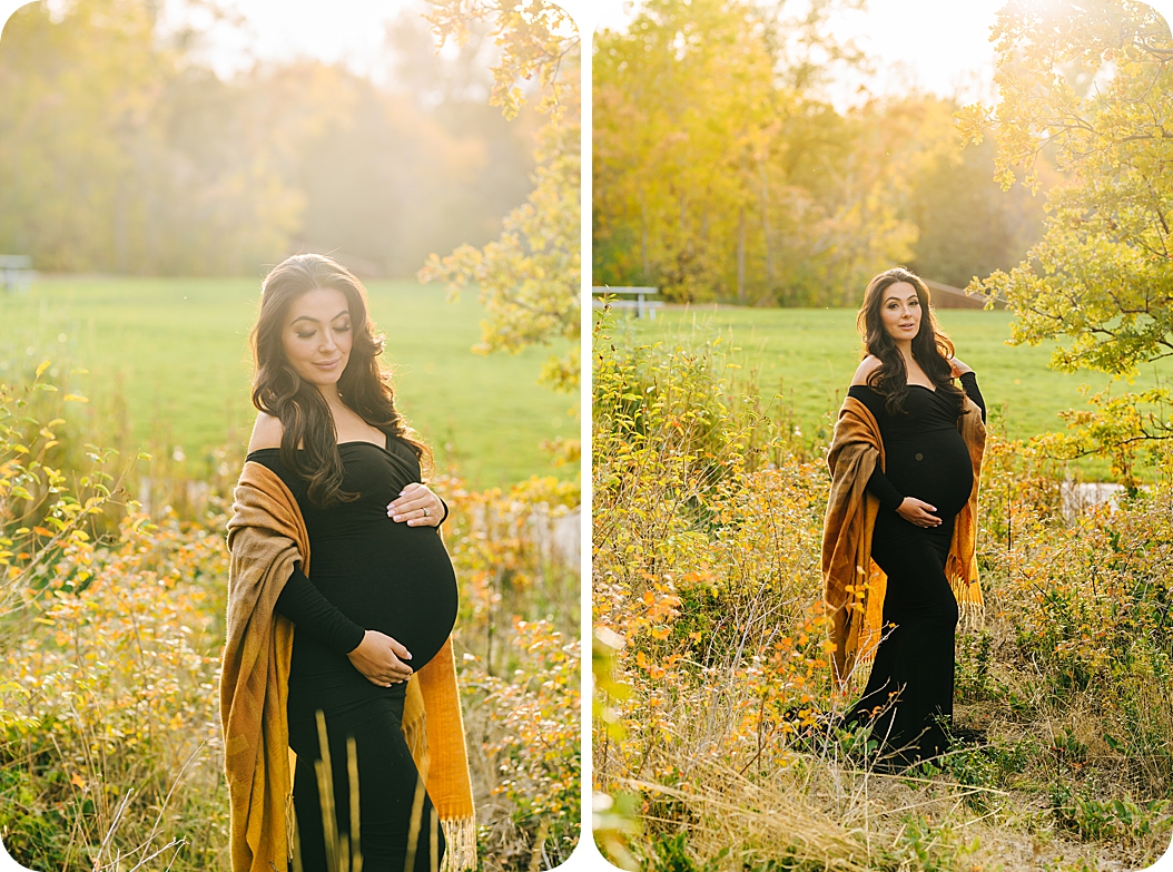 woman stands in field in dark gown with yellow wrap
