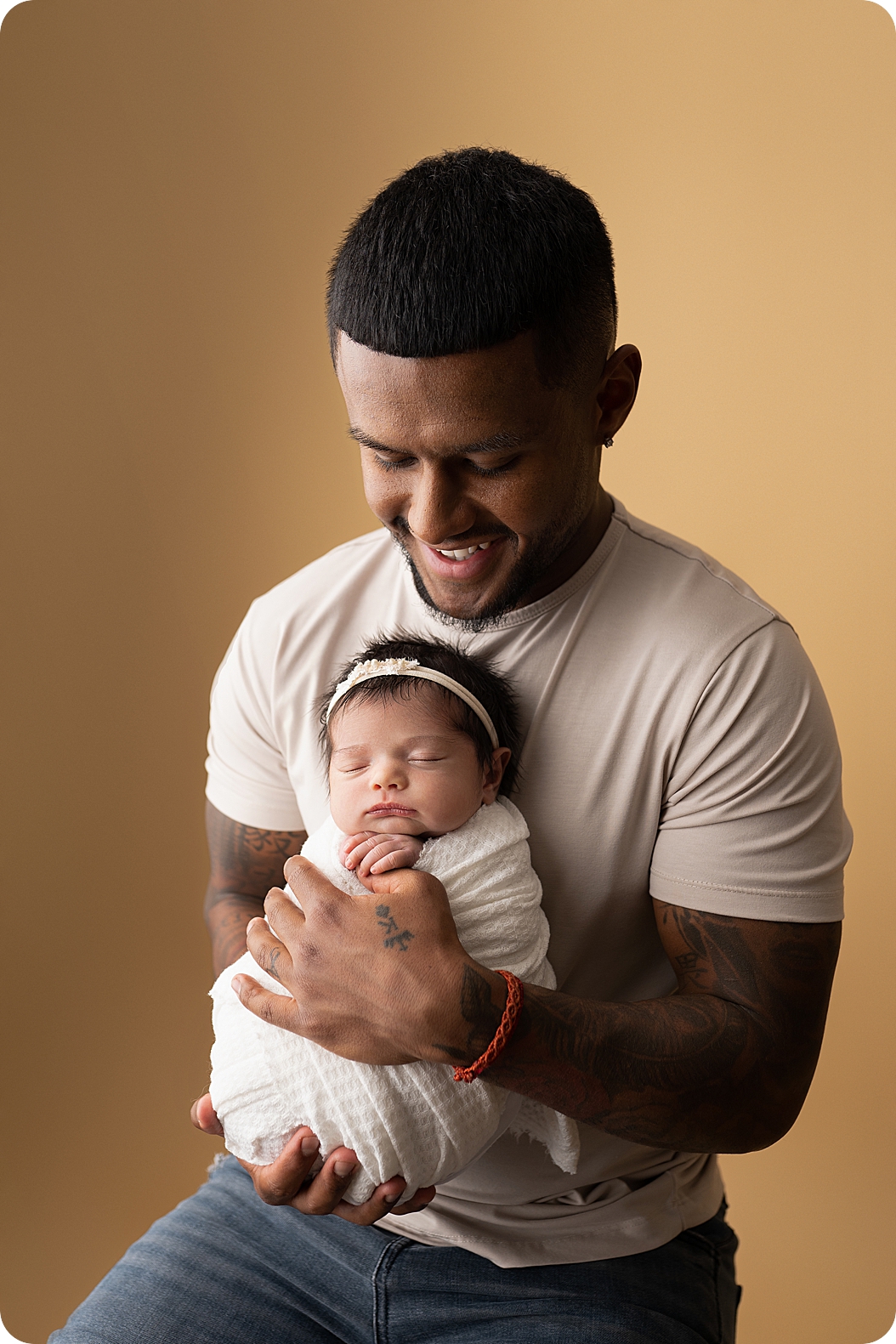 dad holds baby girl during Utah newborn portraits