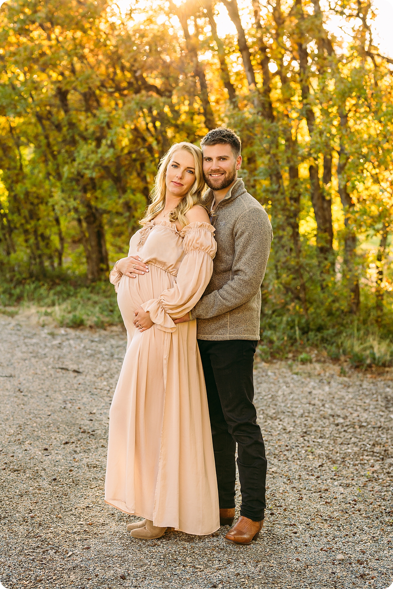 couple holds mom's belly during fall Maternity Session in Utah